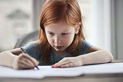 Red hair girl writing