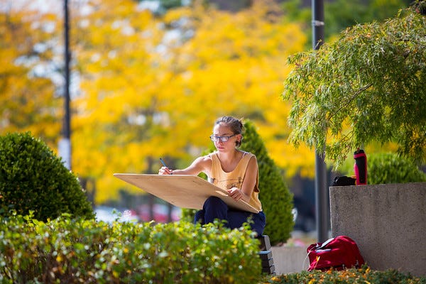 The Draw of the Great Outdoors: Art student drawing outdoors using a drawing board. Photographer: Meredith Forrest Kulwicki