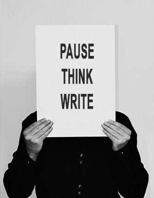 Man holding sign saying Pause, Think, Write