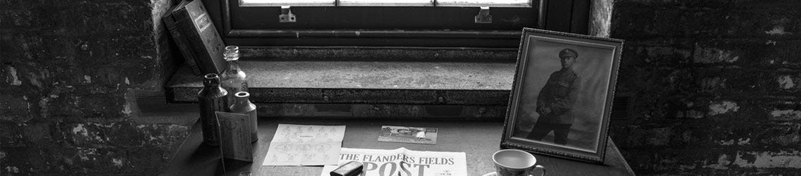 An old desk showing WWI newspaper and a photo of a soldier