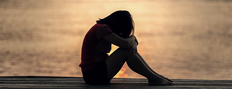 Woman looking tired or stressed in natural setting